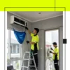 Dua Teknisi Sedang Servis AC di Jakarta Barat